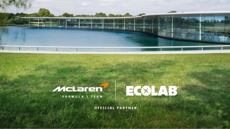McLaren Formula 1 Team and Ecolab logos on a greenery and water background around the McLaren headquarters