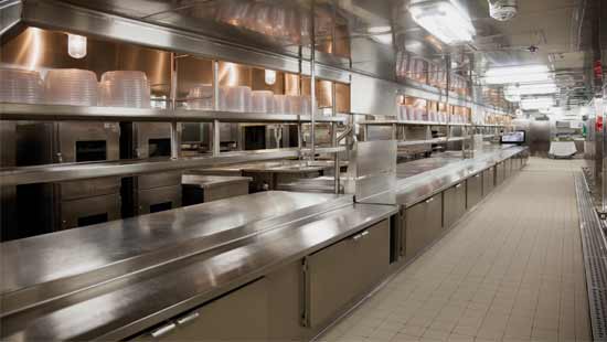Sani Wash N Walk Restaurant kitchen with clean floors and shining silverware equipment after receiving floor and commercial drain cleaning treatment.