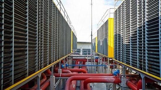 View of side walls and pipes of a very large data center cooling system 