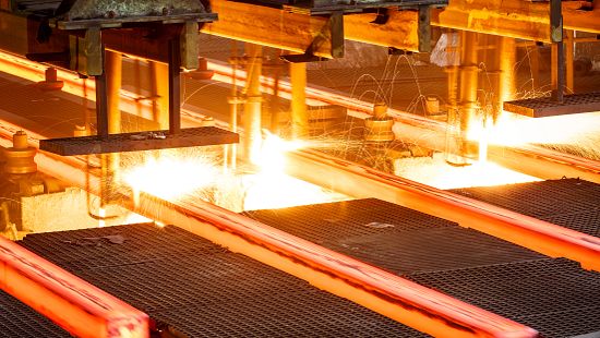 Steel beams passing through hot mill